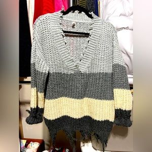 Multicolored sweater w/ fringe along neck, cuff and bottom.
